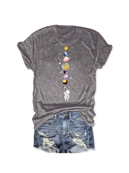 Women's casual style T-shirt with astronaut and planets design, space-inspired, ideal for science enthusiasts and urban fashion fans