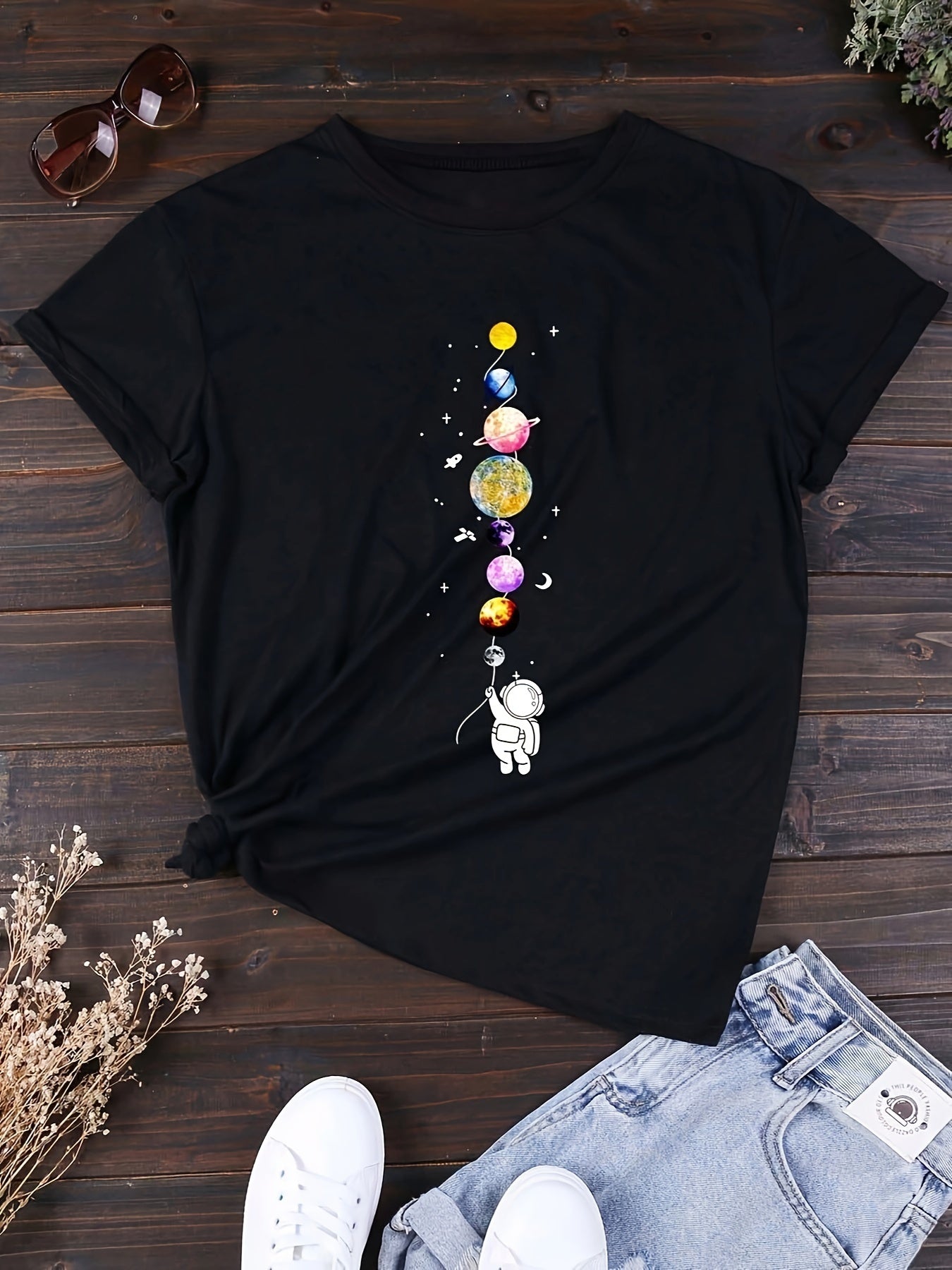 Women's casual style T-shirt with astronaut and planets design, space-inspired, ideal for science enthusiasts and urban fashion fans