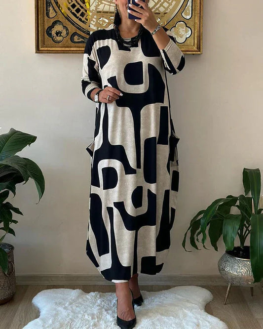 Lynda – Robe Maxi Fluide avec Imprimé Art Audacieux et Design Élégant Sans Manches